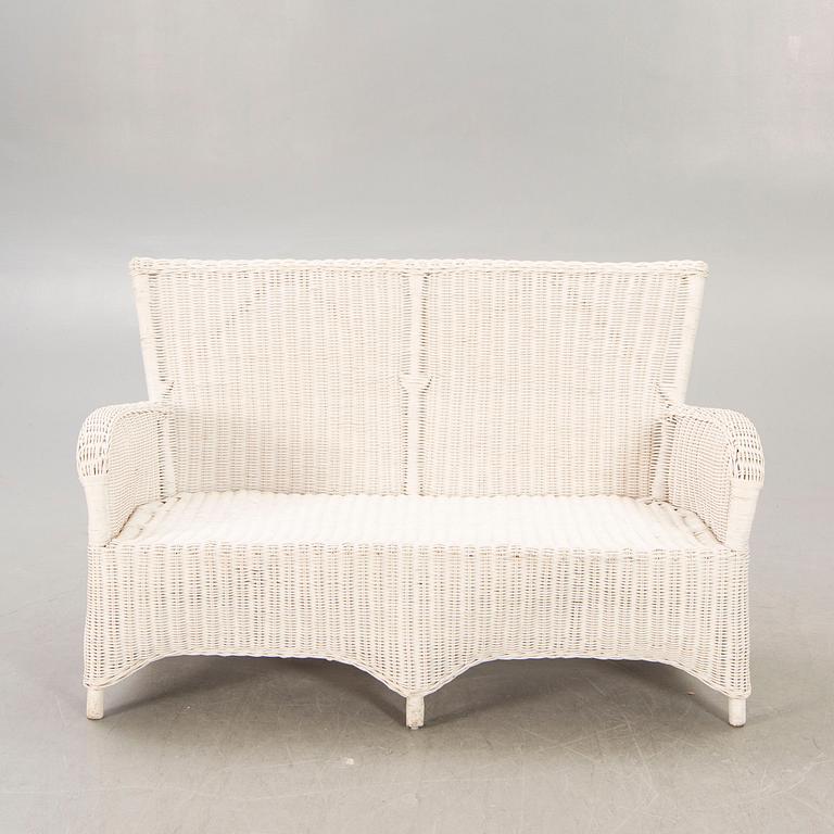 An Artwood rattan sofa.