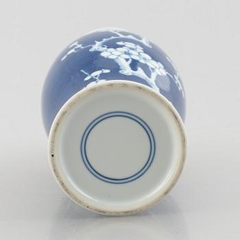 A Chinese porcelain dragon bowl, Qing dynasty, 19th century, and a blue and white porcelain vase, China, 20th century.