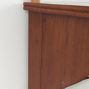 A mahogany veneered mirror with console table. First part of the 19th century.