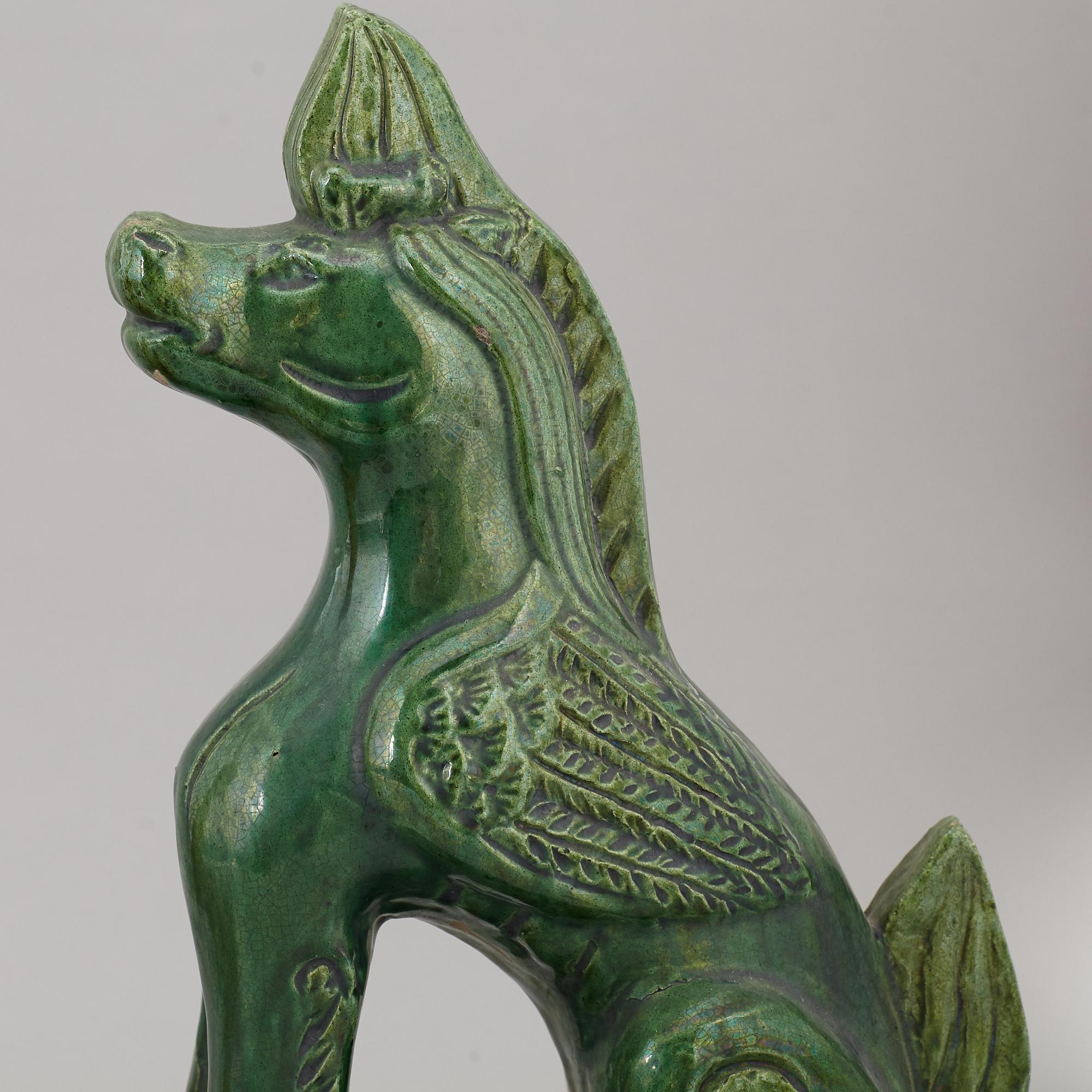 A group of three Chinese glazed roof tiles of seated animals, 20th century.