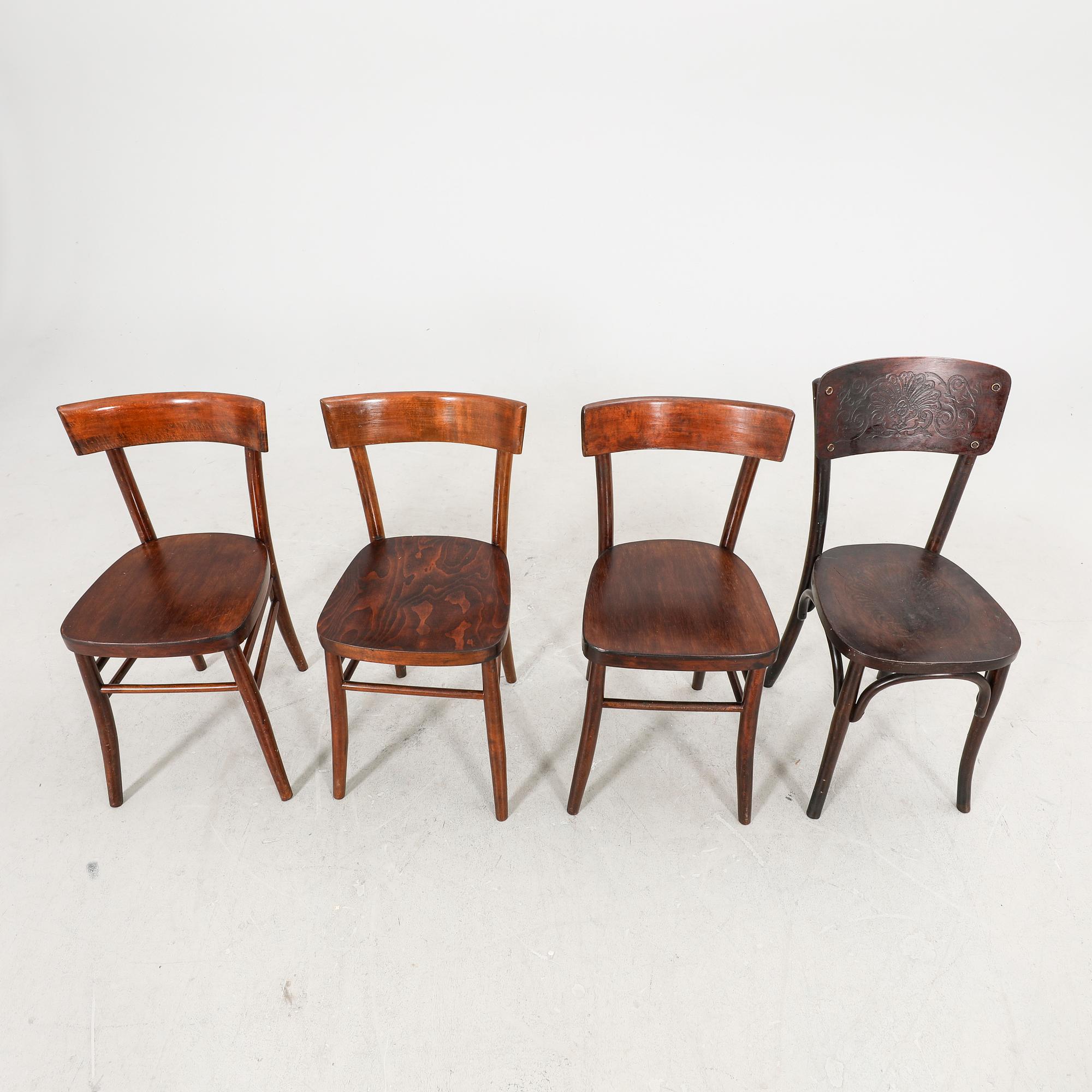 A set of four different early 1900s chairs.