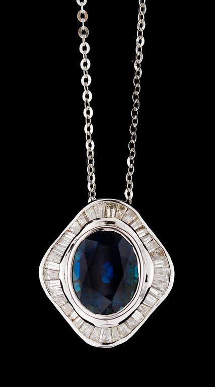 A gold diamond and blue sapphire pendant.