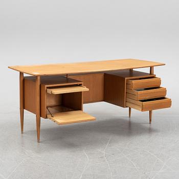 A teak veneered writing desk, 1950's/60's.