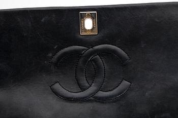 A black quilt leather shoulder bag by Chanel.