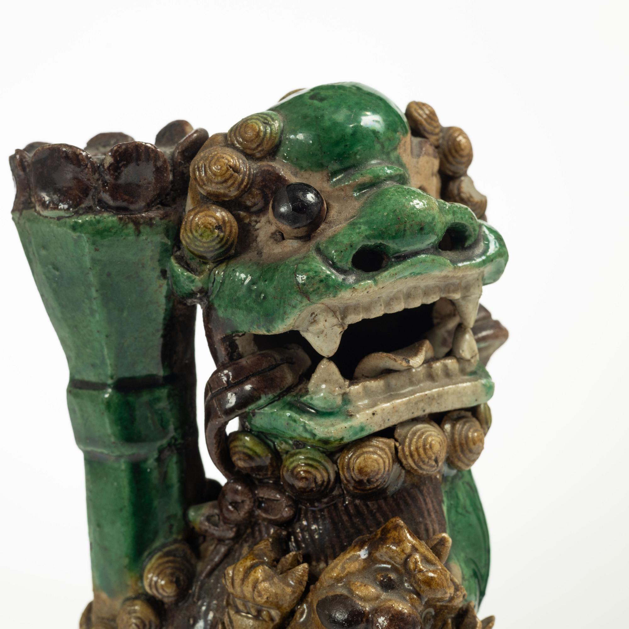 A Sancai glazed Buddhist lion incense/joss stick holder, Qing dynasty, Kangxi (1662-1722).