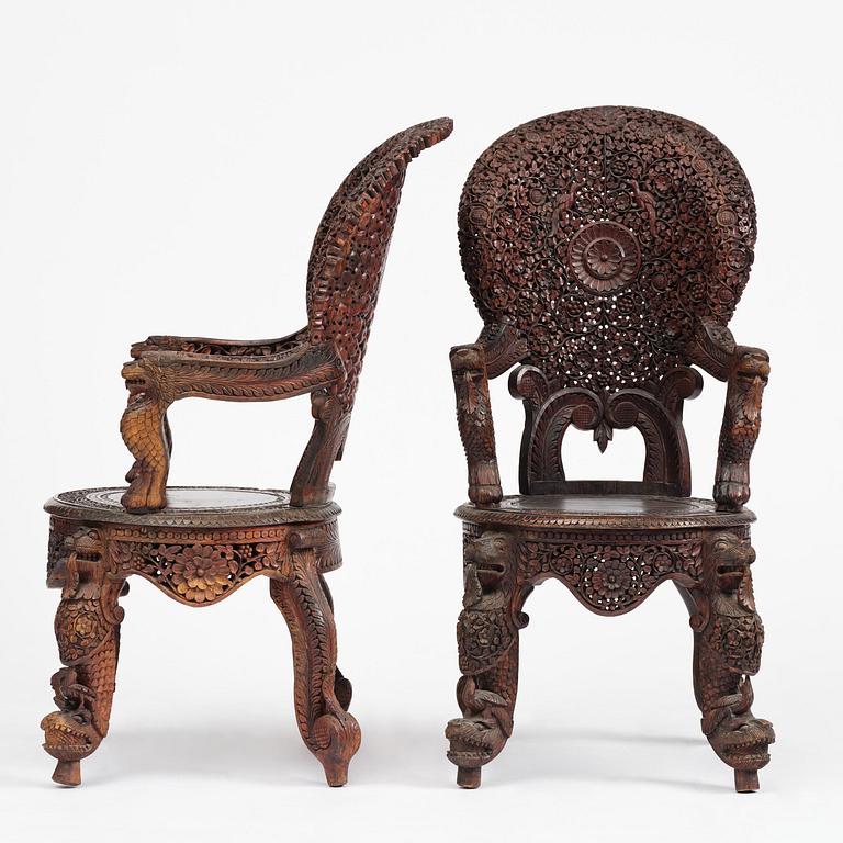 A pair of carved 'blackwood' armchairs, Bombay presidency, British Raj, circa 1880.