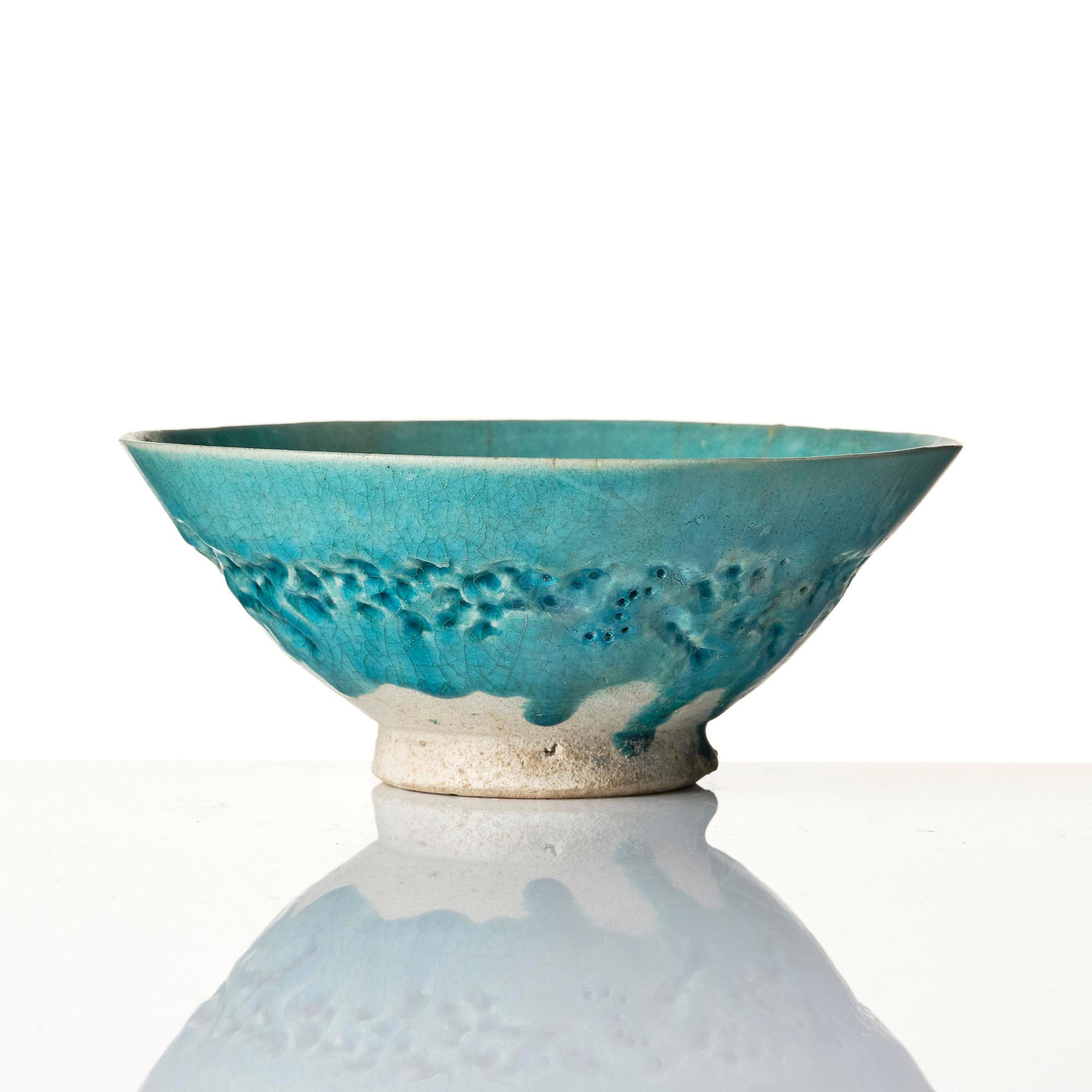 A Kashan Turquoise glazed conical pottery bowl, central Persia, 13th century.
