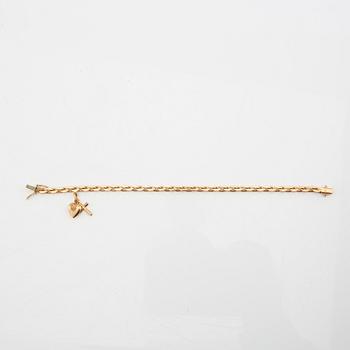 Bracelet with rounded anchor link in 18K gold with charms.