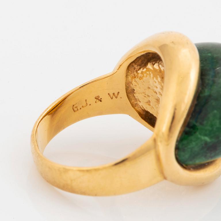 A Georg Jensen & Wendel ring in 18K gold set with a green and black stone.