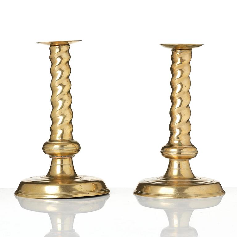 A pair of Northern European cast brass baroque candlesticks, circa 1700.