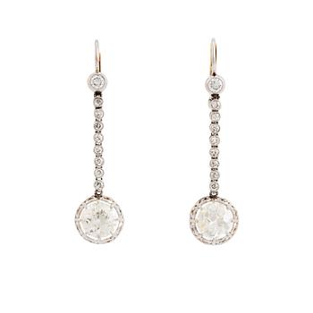 A pair of 18K white gold earrings set with old-cut diamonds.