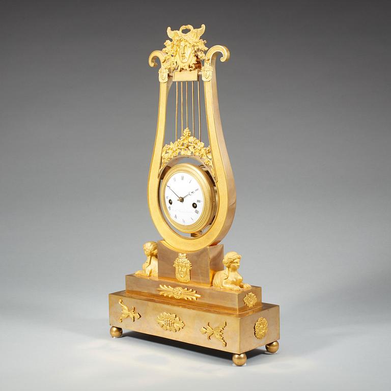 A late Gustavian early 19th century gilt bronze mantel clock.