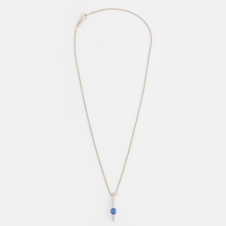 An 18K white gold necklace with a faceted sapphire.