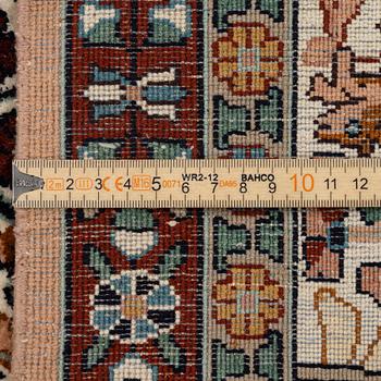 An oriental silk carpet, c. 305 x 205 cm.