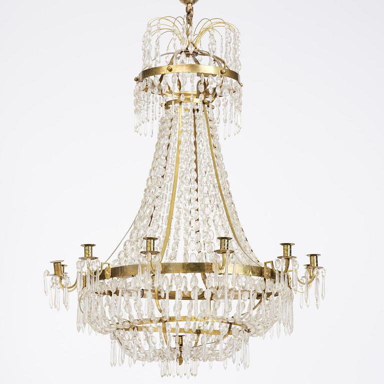 A Swedish gilt brass and cut glass thirteen-light Empire chandelier, early 19th century.