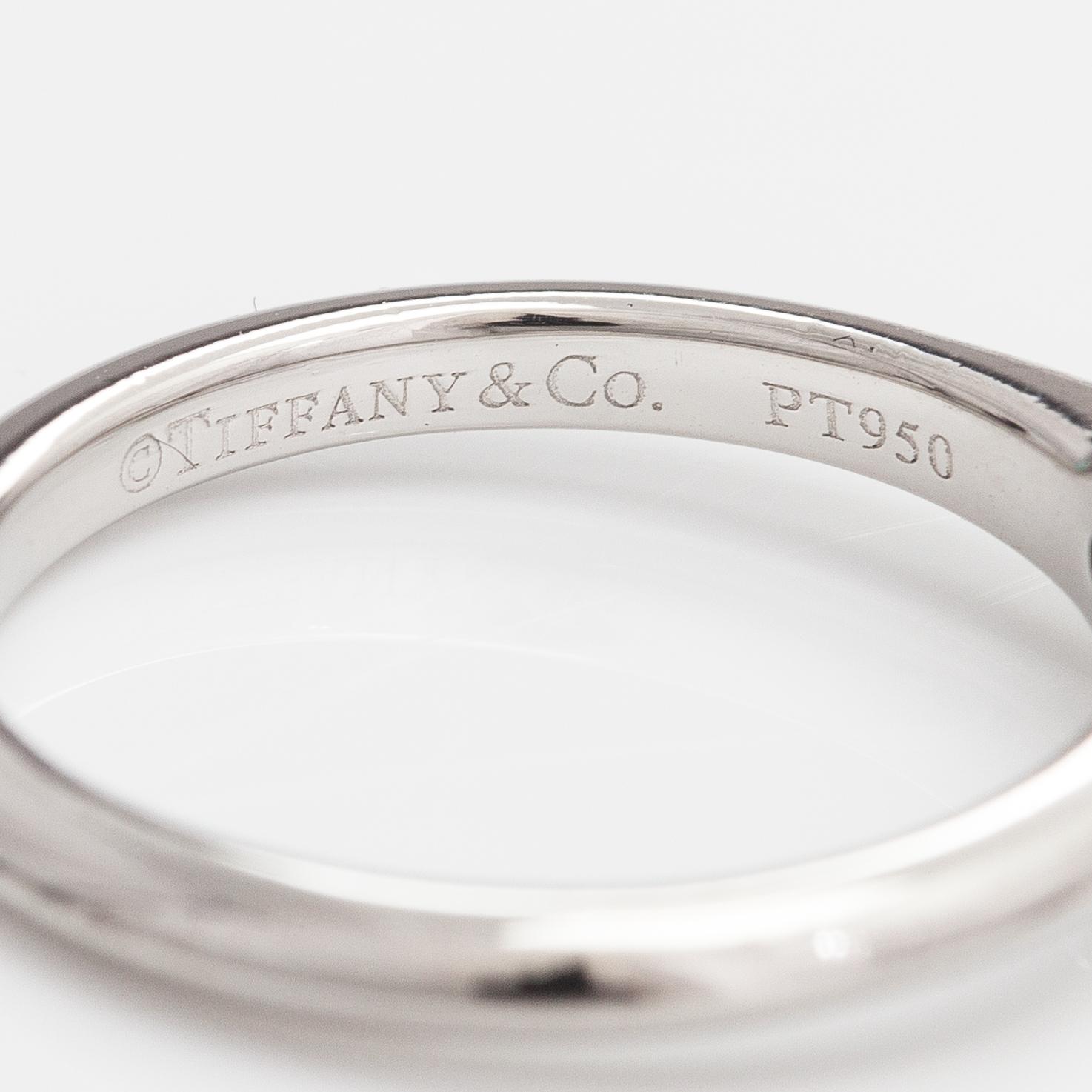 Tiffany & Co, A platinum ring with a ca. 0.26 ct diamond.