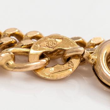 Kaulakoru, 14K ja 18K kultaa, tupsuriipuksella. Sveitsi ja Italia.