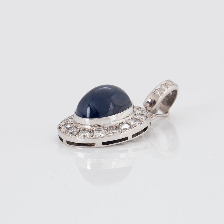 A PENDANT set with an oval cabochon-cut sapphire and round brilliant-cut diamonds.