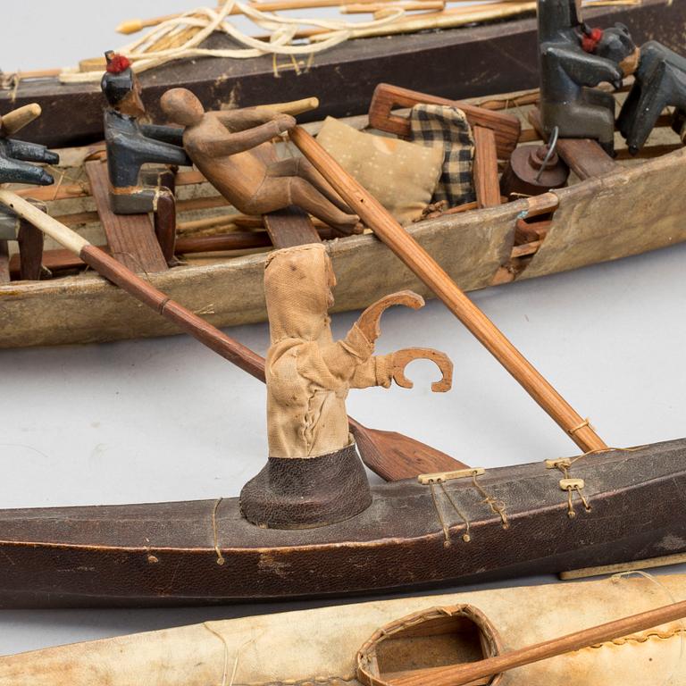 AN UMIAK AND THREE KAJAKS, MODEL BOATS GREENLAND, WITH FIGURES, PADDLES, SPEERS ETC.