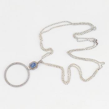A platinum lorgnette set with a faceted sapphire and rose-cut diamonds.