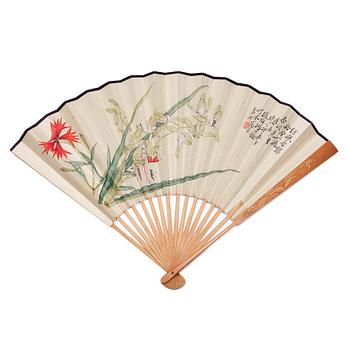 987. A Chinese fan signed Tang Xinyu, and dated to 1927 in an embroidered silk case.