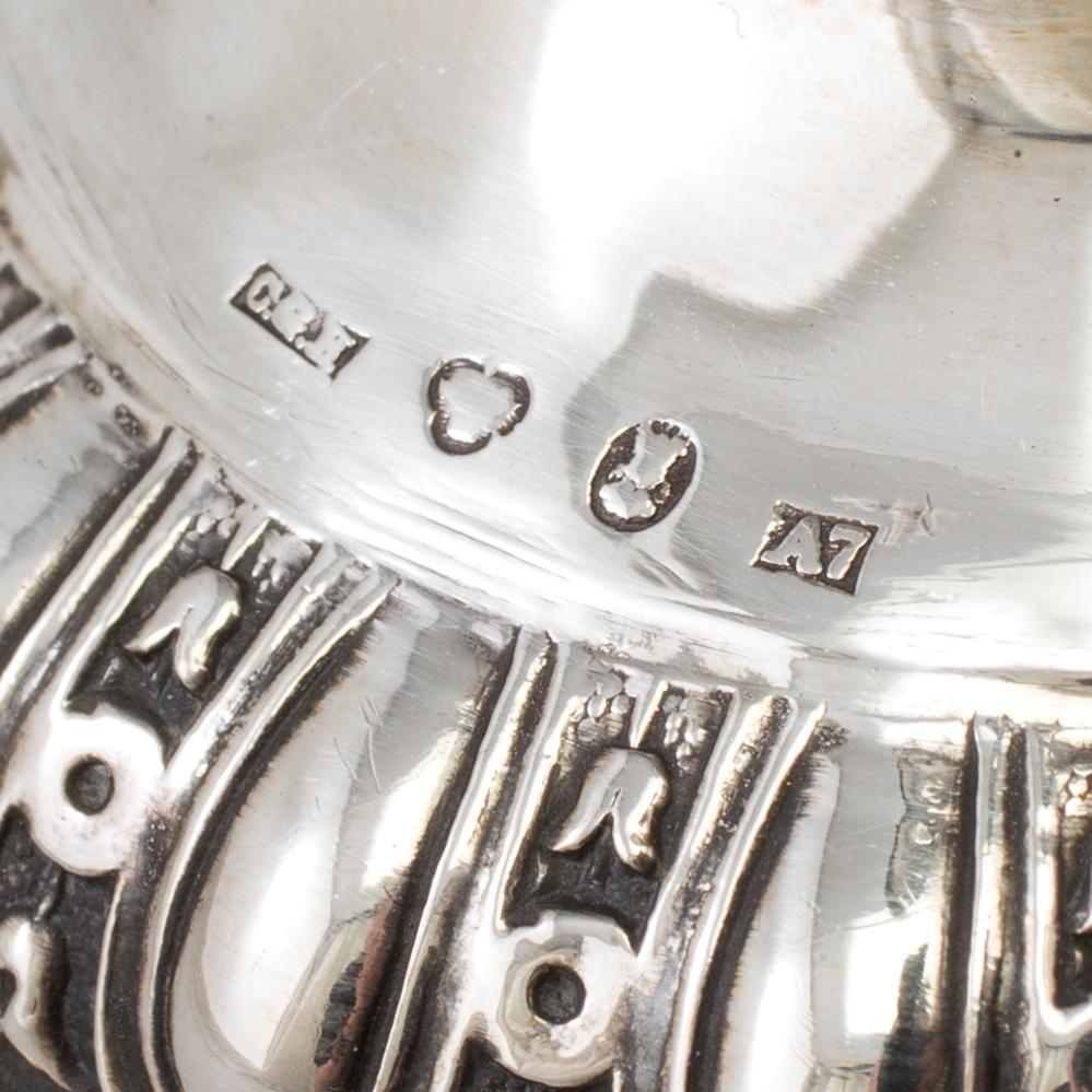A pair of silver candle sticks, dated 1903.