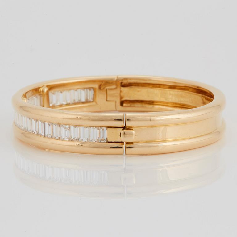 An 18K gold bracelet set with baguette-cut diamonds 7.715 cts according to engraving.