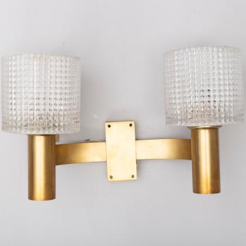 A pair of the 20th century brass and glass wall lights.