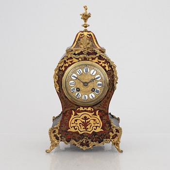 A Louis XV-style mantel clock, late 19th century.