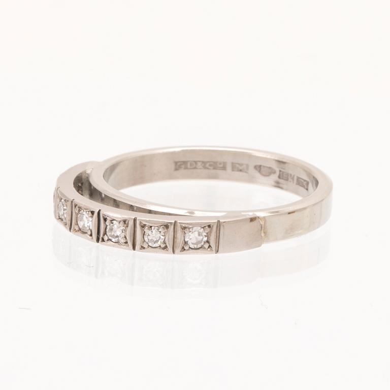 An 18K white gold ring set with round single cut dimamonds.