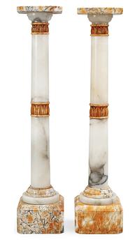 698. A pair of 20th century alabaster and marble pedestals.