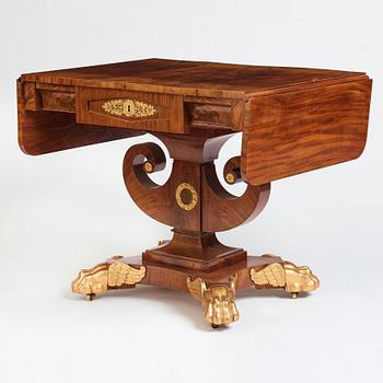 A Swedish Empire mahogany center table by Johan Öman, (Stockhom 1815-1833).