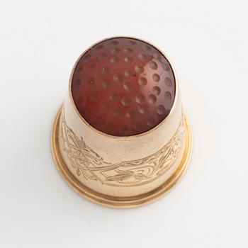 An 18K Gold Thimble with carnelian.