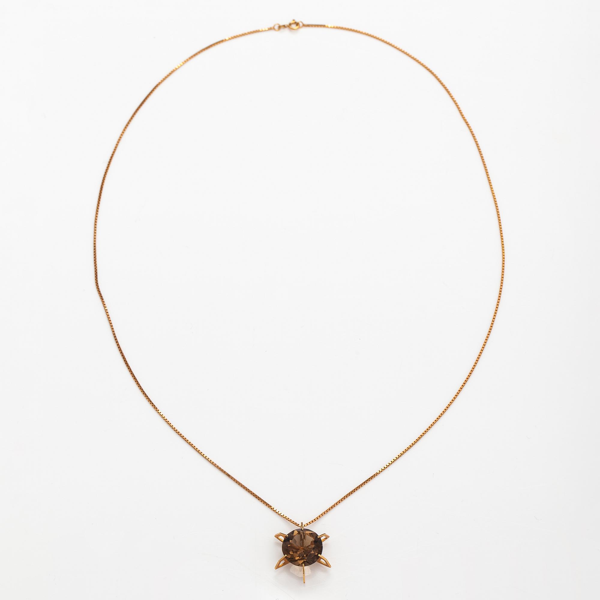 A 14K gold necklace with a smoky quartz. Martti Tapio Aarnio, Helsinki 1966.