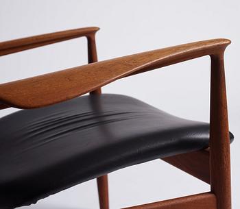 Finn Juhl, a teak and black leather 'model 136' easy chair, France & Daverkosen, Denmark 1950-60s.