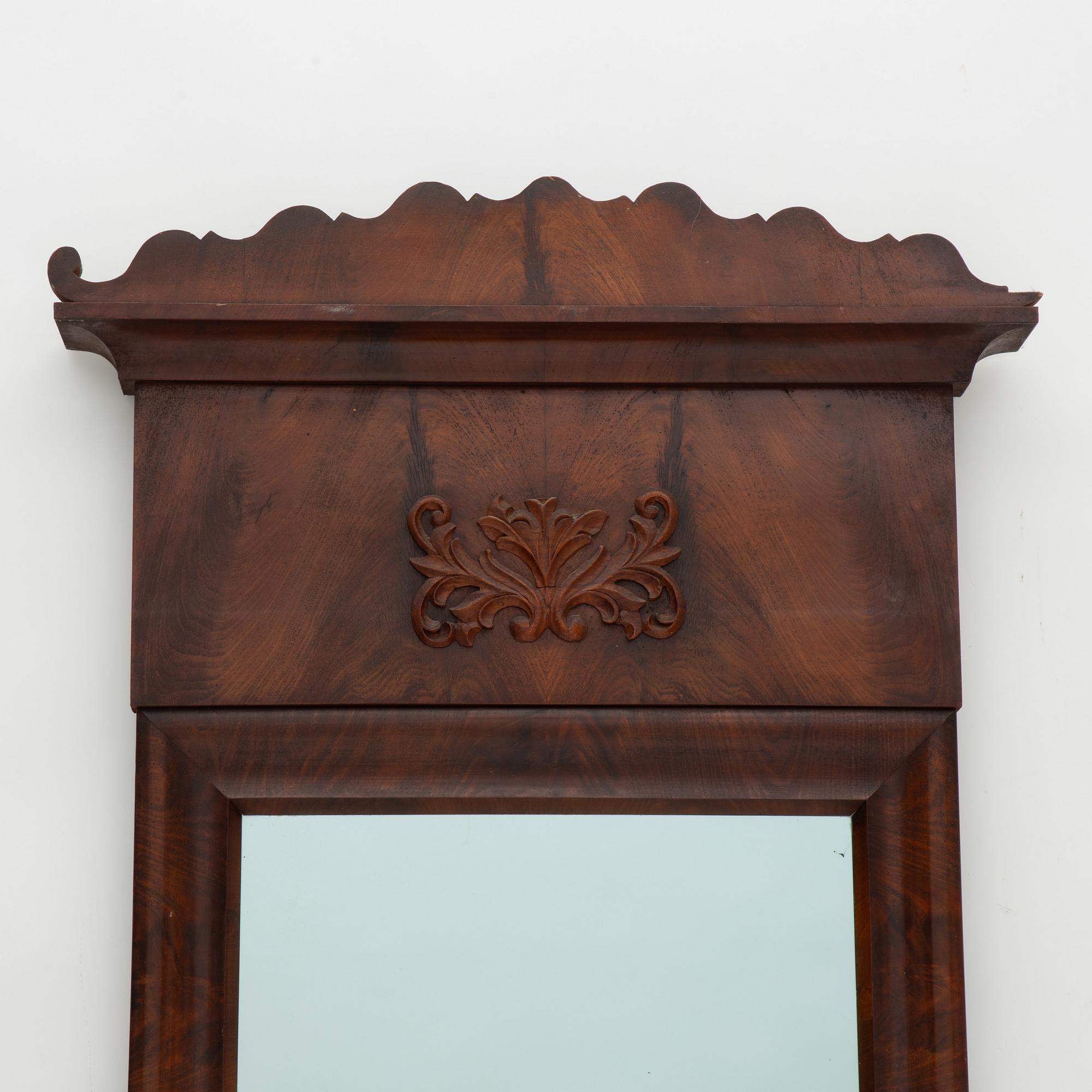 A Swedish Empire mirror with a console table, first half of the 19th Century.