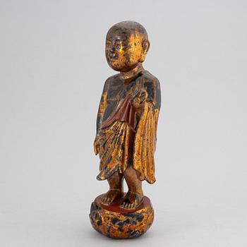A Chinese wood gilt and lacquer sculpture of a boy, 20th Century.