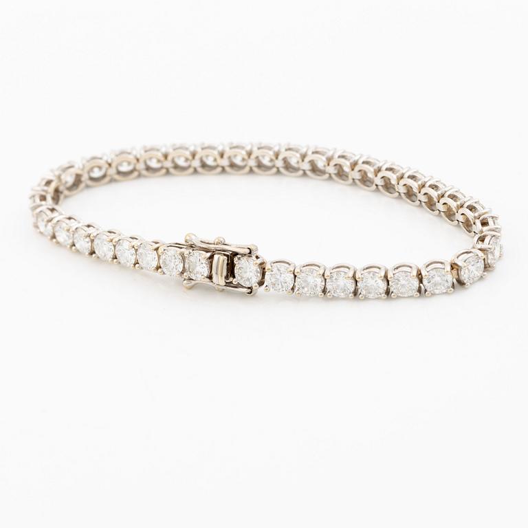 A tennis bracelet in 18K white gold set with round brilliant-cut diamonds total ca 11.50 ct, accompanied by GIA dossier.