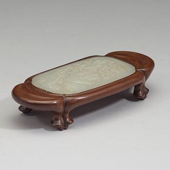 A nephrite plaque mounted as a wrist-rest, Qing dynasty (1644-1912).