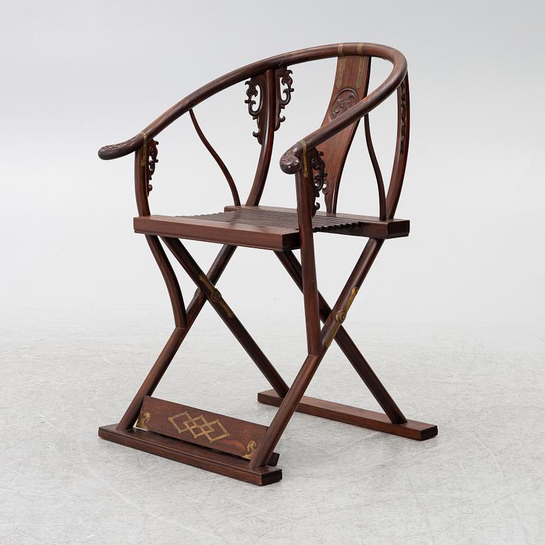 A Chinese hardwood folding chair, 20th century.