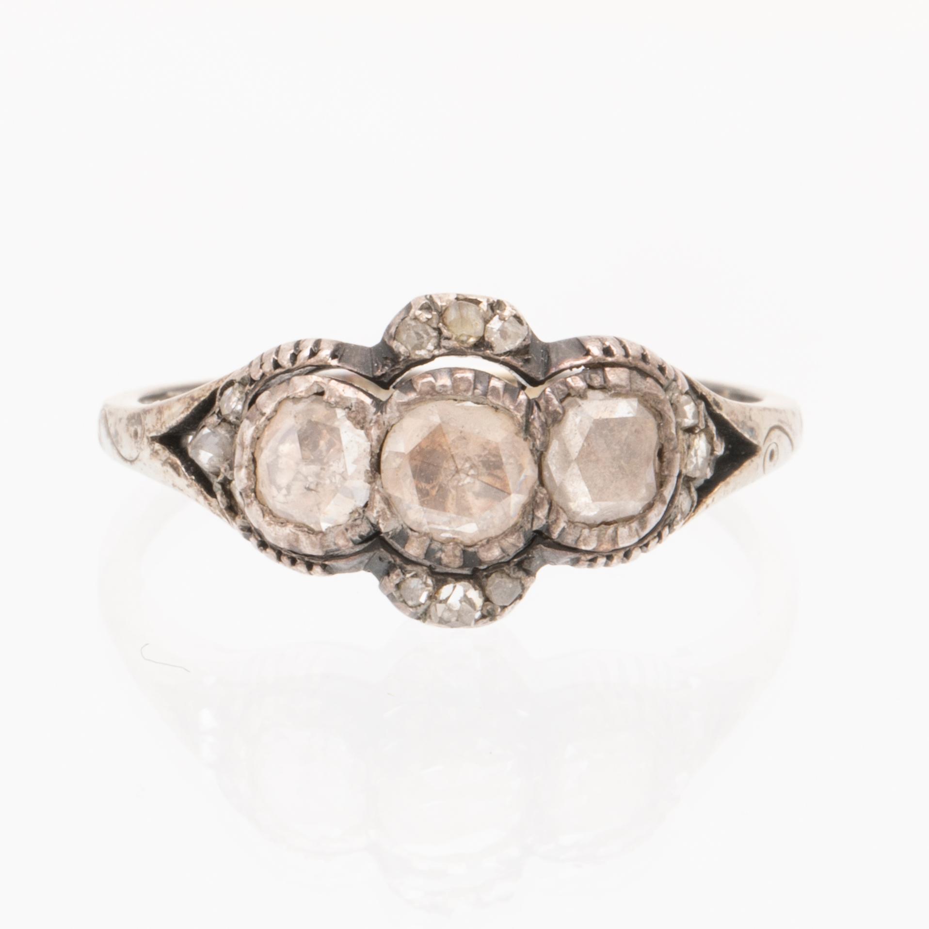 An 18K white gold ring set with rose cut diamonds.