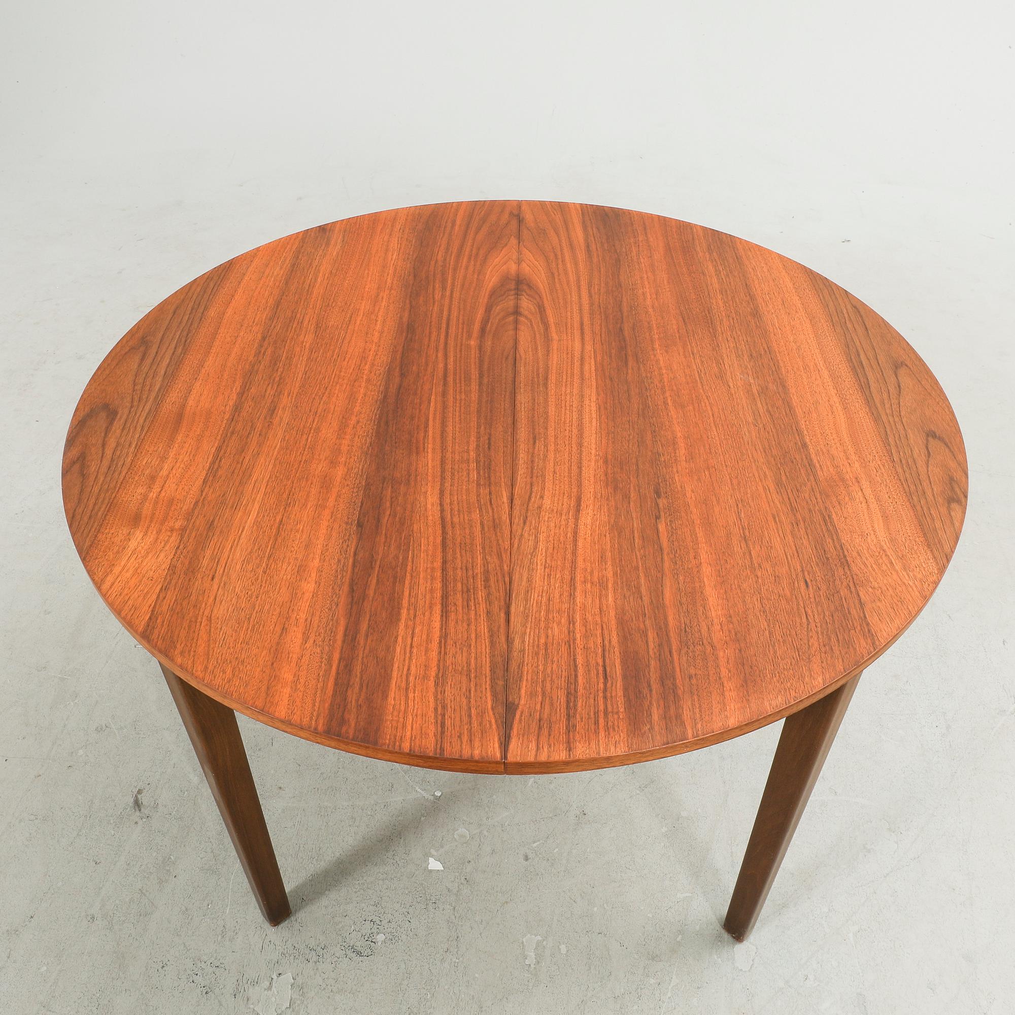 A 1960s walnut dining table.