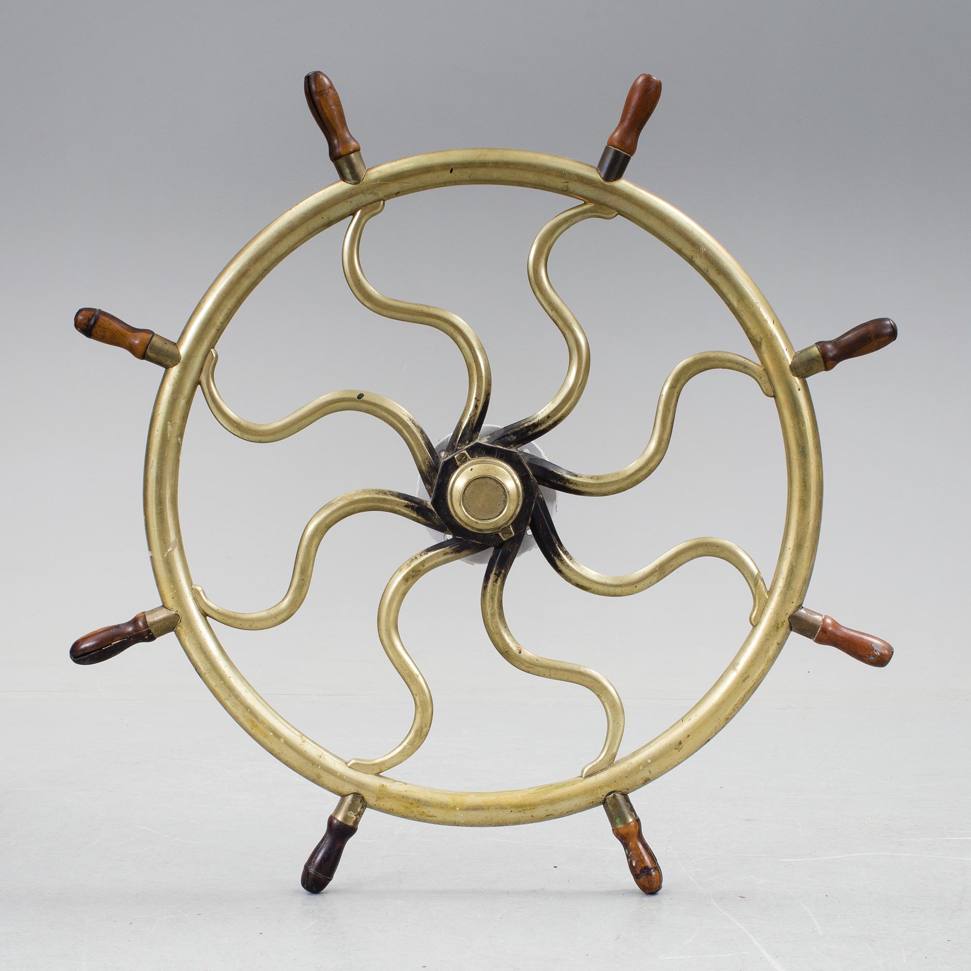 A ship steering wheel, about 1900.