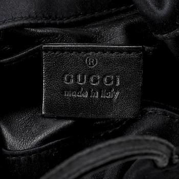 GUCCI, a black silk evening bag.