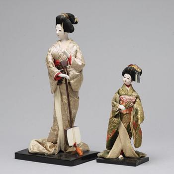 Two Japanese dolls and a box with minitures, 20th Century.