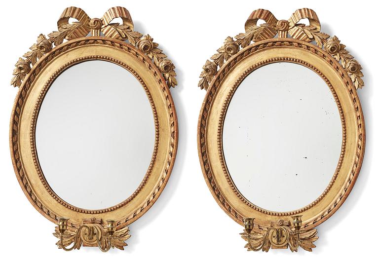 A pair of two-branch Gustavian-style giltwood mirrored girandoles, 19th century.