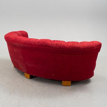 A 1930s curved sofa by Greta Magnusson Grossman for Firma Studio.