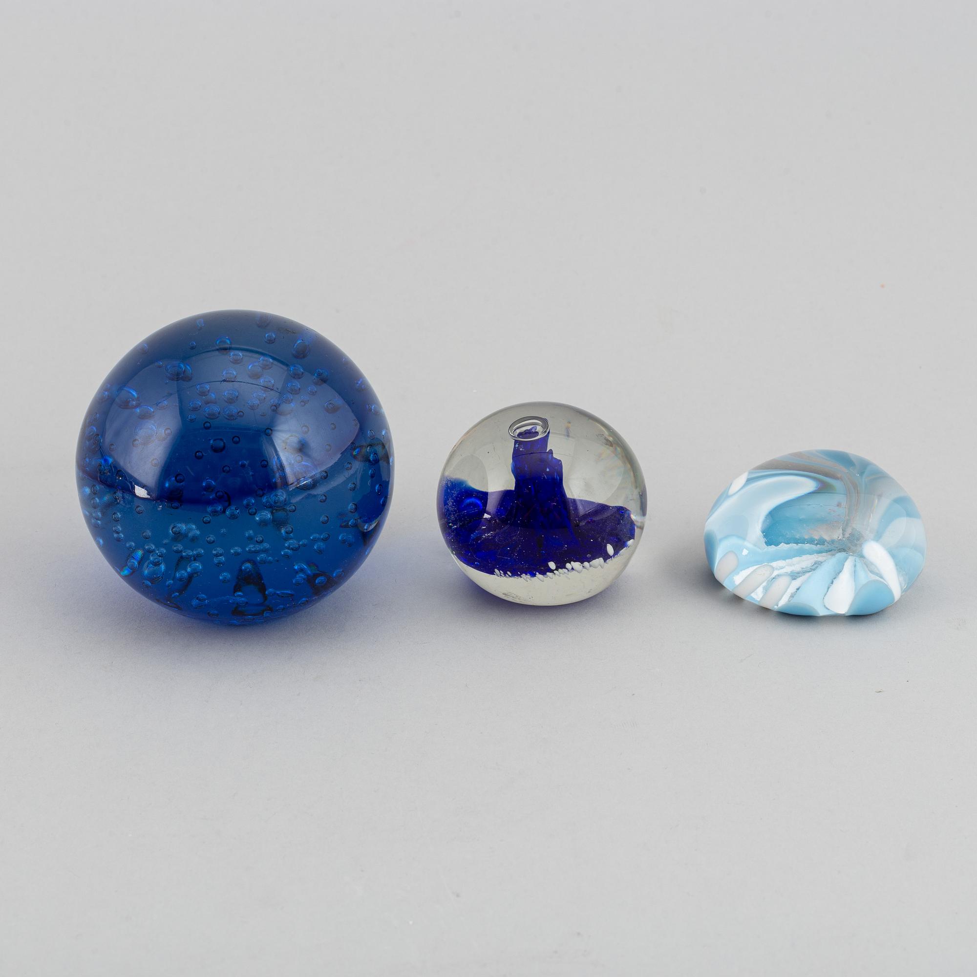 A group of 12 glass paper weights.