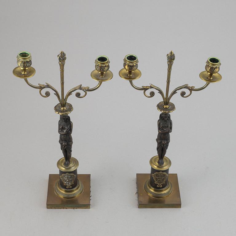 A pair of brass Empire style candle holders, 20th century.
