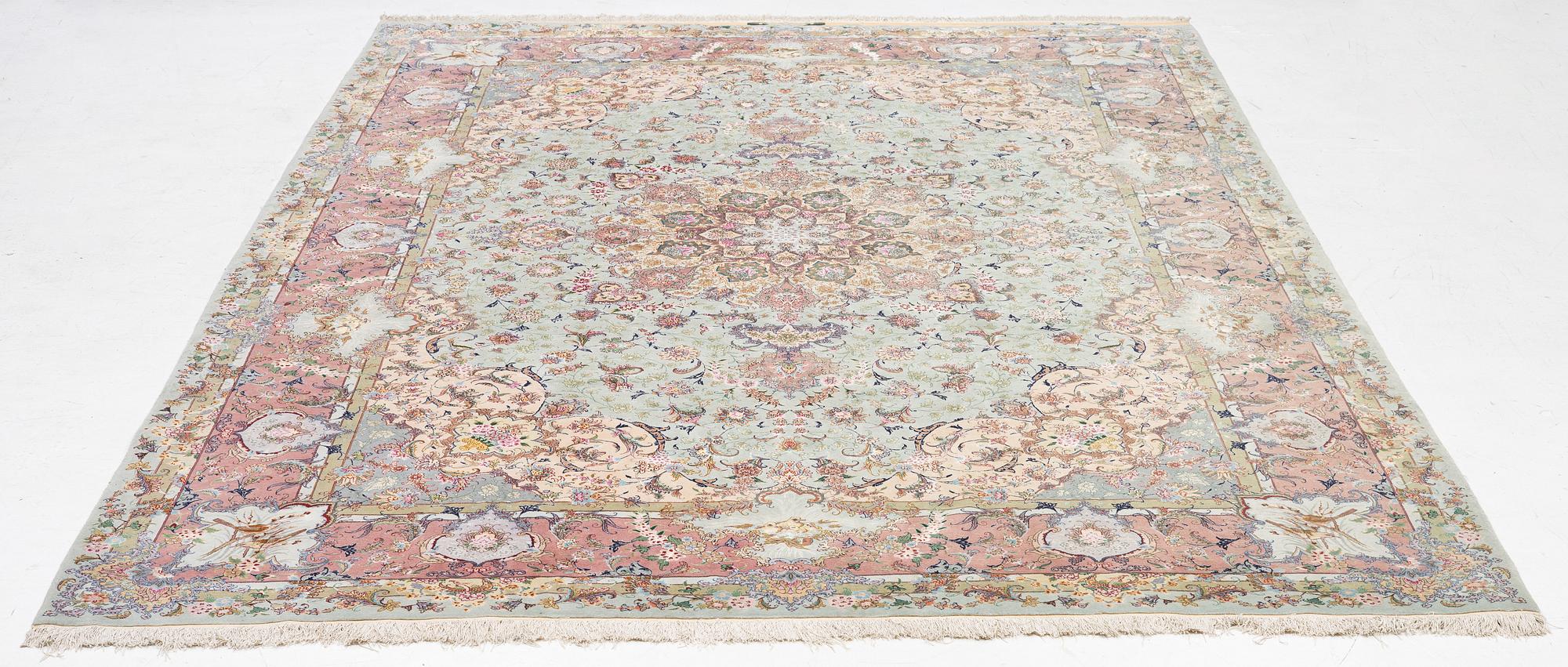 A Tabriz carpet, part silk, approx. 367 x 250 cm.
